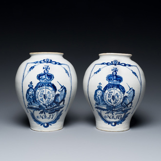 A pair of Dutch Delft blue and white tobacco jars with the royal British coat of arms, late 18th C.