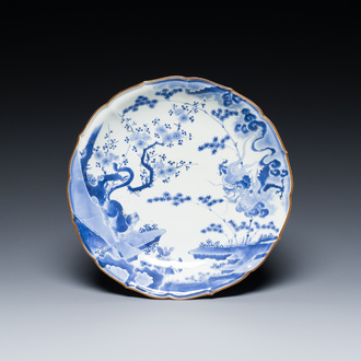 A Japanese blue and white Arita dish with a tiger and a dragon in Kakiemon-style, Fuku mark, Edo, late 17th C.