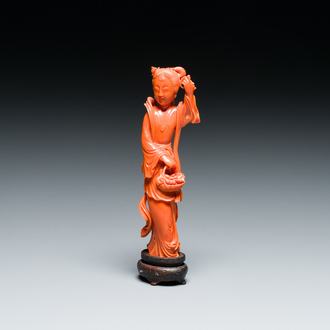 A Chinese red coral figure of a lady holding a fruit basket, 19/20th C.