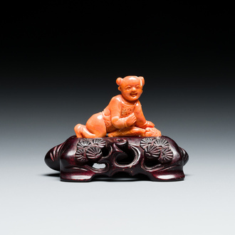 A Chinese red coral figure of a boy, 19/20th C.