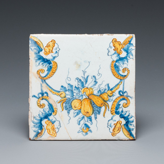 An extremely rare polychrome Dutch Delft tile with garlands and mascarons, 17th C.