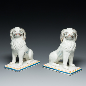 A pair of polychrome Brussels faience models of pugs, one inscirbed 'Jellie' and dated 1781