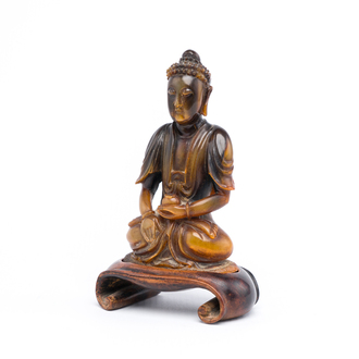 A Chinese carved horn figure of the Medicine Buddha or Bhaishajyaguru, 19th C.