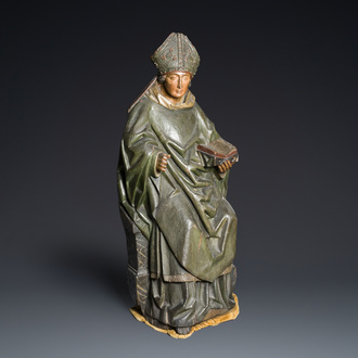 A large polychromed wood sculpture of a seated bishop, probably France, early 16th C.