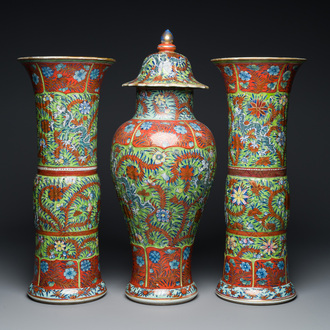 A Chinese English-decorated blue and white garniture of three vases, Kangxi