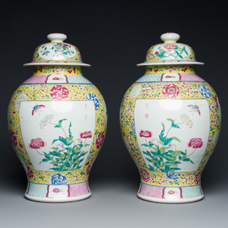 A pair of Chinese yellow-ground famille rose vases and covers, 19th C.