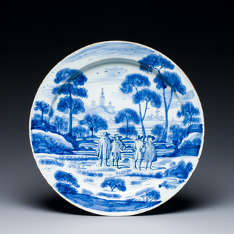 A large blue and white Dutch Delft dish with refined design of gentlemen in a landscape, 18th C.