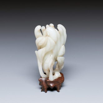 A fine Chinese white jade carving of a Buddha's hand on wooden stand, Qing