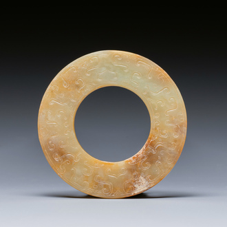 A Chinese celadon and russet jade 'bi' disc, probably Han