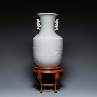 A Chinese white-glazed vase on wooden stand, 19th C.