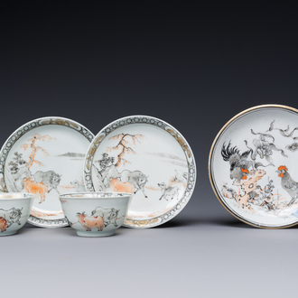 A pair of Chinese grisaille and iron-red 'buffalo' cups and saucers and a 'rooster' saucer, Yongzheng