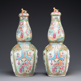 A pair of Chinese Canton famille rose double gourd vases and covers, 19th C.