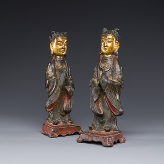 A pair of Chinese partly lacquered and gilt bronze figures of female attendants, Ming