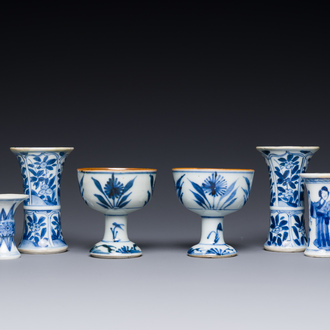 Two Chinese blue and white stem cups and four miniature 'gu' vases, Kangxi