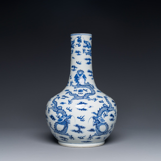 A Chinese blue and white bottle vase with dragons among flames and clouds, 19th C.