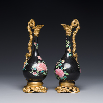 A pair of Chinese black-ground famille rose vases with gilt bronze mounts, Yongzheng