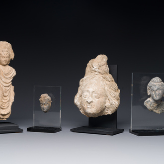 Two small Gandhara grey schist Bodhisattva heads, a stucco sculpture of Bodhisattva and a stucco female head, 1/4th C.