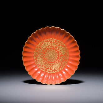 A Chinese coral-red-glazed gilt-decorated 'lotus scroll' saucer, Jiaqing mark, Republic