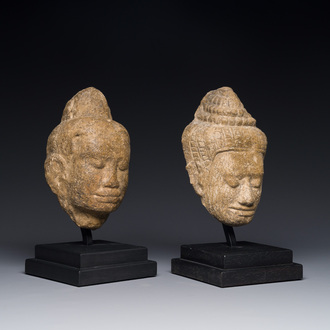 A stone head of Buddha and a sandstone khmer head of a deity, Bayon style, Cambodia, 12/13th C.