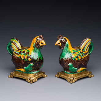 A pair of Chinese sancai-glazed chicken ewers mounted as candleholders with gilt bronze, Kangxi