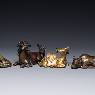 A group of four Chinese gilt bronze paper-weights, Ming/Qing