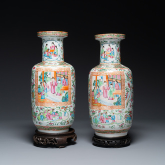 A pair of Chinese Canton famille rose vases with wooden stands, 19th C.