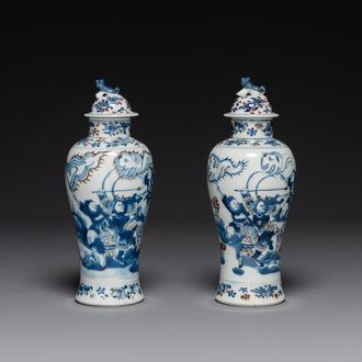 A pair of Chinese blue, white and copper-red vases and covers, Kangxi mark, 19th C.