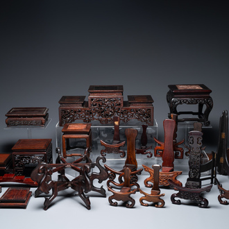 A collection of 26 varied Chinese wooden stands, 2 with marble tops, 19/20th C.