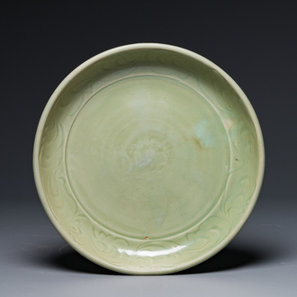 A Chinese Longquan celadon dish with floral anhua design, Ming