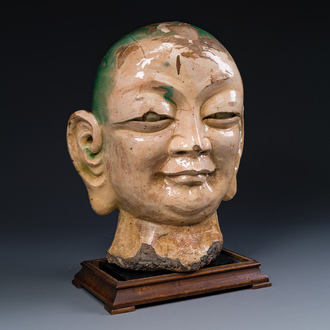 An imposing Chinese sancai glazed stoneware head of a monk, Yuan/Ming