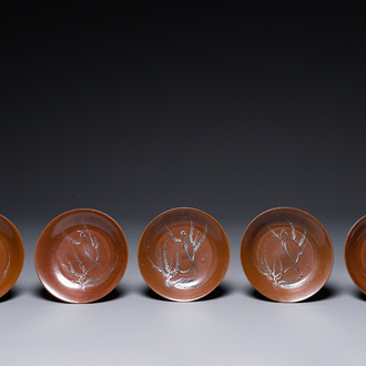 Five Chinese slip-decorated brown-glazed 'bird on blossoming plum tree' plates, Fujian kilns, late Ming, 16/17th C.