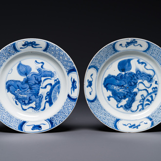 A pair of Chinese blue and white 'Buddhist lion' plates, ding mark, Kangxi