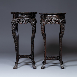 A pair of tall Chinese carved wooden stands with marble tops, 19th C.