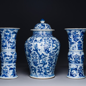 A Chinese blue and white garniture of three vases with floral and landscape design, Kangxi