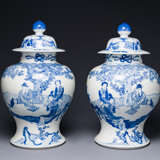 A pair of Chinese blue and white covered vases with figural design, 19th C.