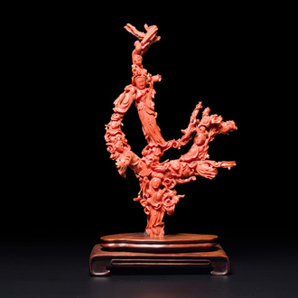 A large Chinese red coral group of female deities among clouds on wooden stand, 19/20th C.