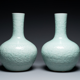 A pair of large Chinese monochrome celadon-glazed anhua 'lotus scroll' bottle vases, 19th C.