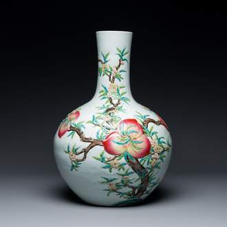 A Chinese famille rose relief-molded 'tianqiuping' vase with nine peaches, Qianlong mark, 19/20th C.