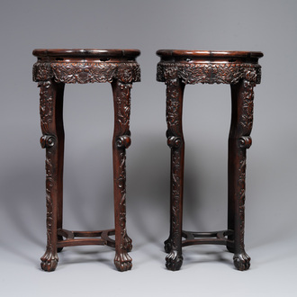 A pair of tall Chinese carved wooden stands with marble tops, 19th C.