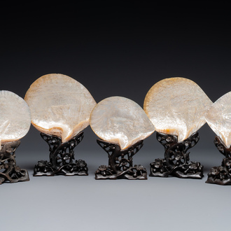 Five Chinese carved mother-of-pearl shells on wooden stands, Canton, 19th C.