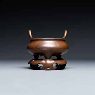 A Chinese bronze tripod censer on a stand, Xuande mark, 19th C.