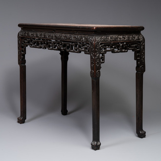 A rectangular Chinese carved wooden console table with a pink marble top, 19th C.