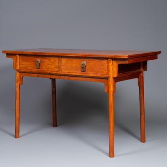 A Chinese huanghuali wooden two-drawer recessed-leg table, 19/20th C.