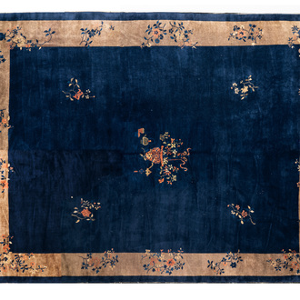 A large Chinese dark-blue-ground carpet with floral design, 19/20th century