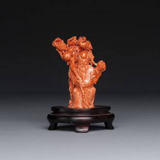 A Chinese red coral figure of Shoulao on wooden stand, 19/20th C.