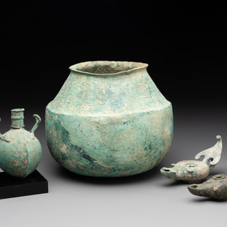 A bronze urn, a bronze canteen with relief design and a pair of bronze oil lamps, Roman Empire, 9th C. B.C/5th C.