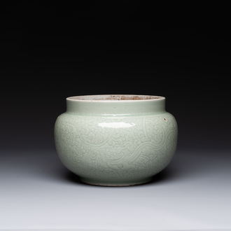 A Chinese monochrome celadon-glazed jar with anhua chilong and floral design, Kangxi