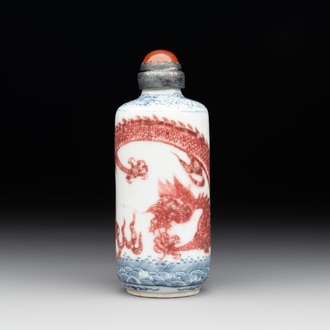 A Chinese blue, white and copper-red snuff bottle with a dragon, dragon mark, 19th C.