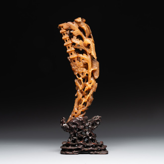 A Chinese buffalo horn carving of a landscape with a pagoda on wooden stand, Qing