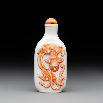 A Chinese moulded iron-red 'chilong' snuff bottle, 19th C.